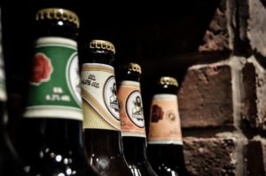 A close up of several different bottles of beer.