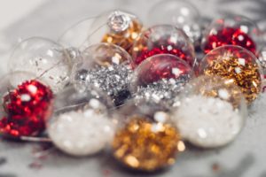 Ornaments filled with red, silver, and gold glitter.