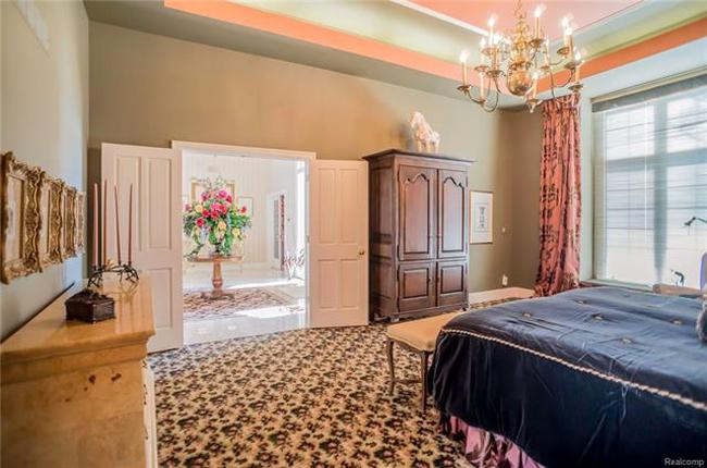 master bedroom with ensuite dressing room and bathroom in plymouth mi luxury home