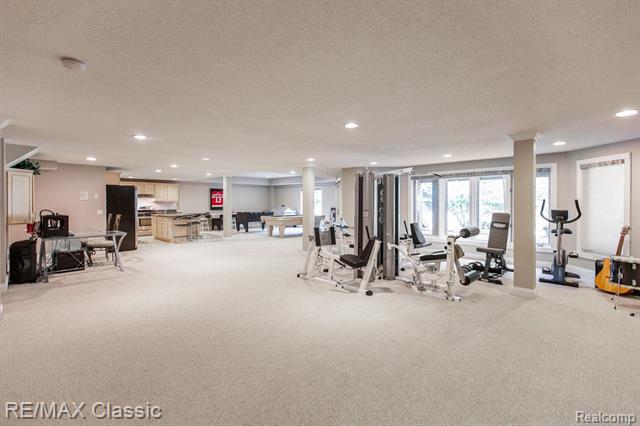 The expansive flex space in this luxurious home, filled with exercise equipment, games, and instruments.